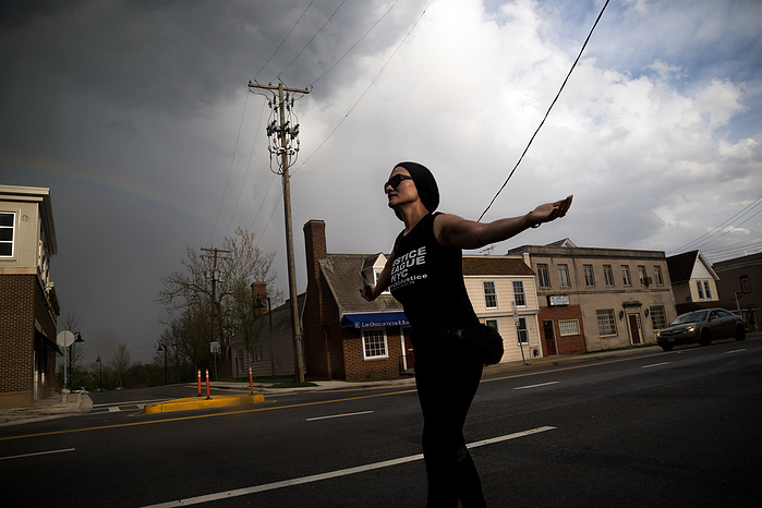 March director Carmen Perez rallies the marchers as they emerge from a rain storm just a mile from Washington, D.C.
