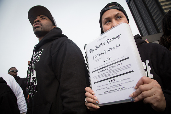 March Director Carmen Perez holds the "Justice Package," three bills designed to outlaw racial profiling, halt the militarization of police forces, and invest in youth delinquency prevention.