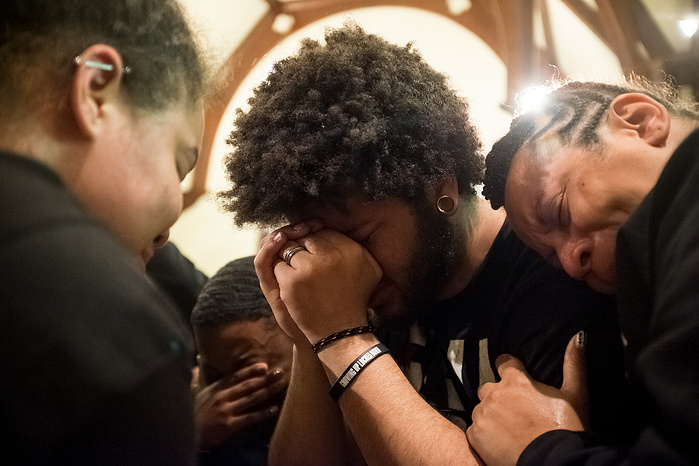 Azizi Curtis and several other marchers are overcome with emotion after hearing a poem by Nicole Webb, a student at Lincoln University. The poem was a plea to God following the death of Trayvon Martin and acquittal of George Zimmerman.