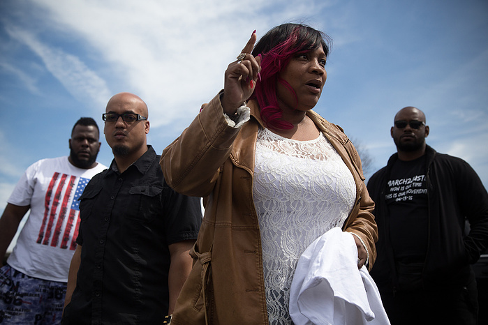 Tanya Dickerson speaks to marchers gathered in a parking lot on the outskirts of Philadelphia. Today was her birthday, as well as the four-month anniversary of the night her 26-year-old son Brandon Tate-Brown was shot in the back of the head by Philadelph