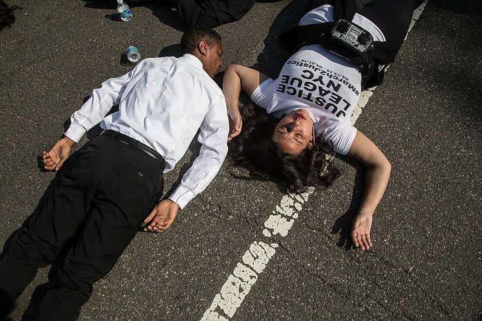 Marchers Anthony Plummer and Mickey Ferrara participate in a die-in outside of the Supreme Court on their way to the final rally at the Capitol building.