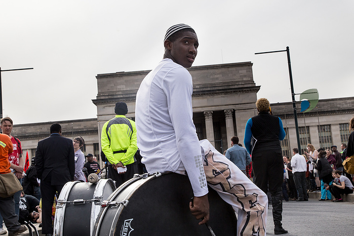 A drummer rests after performing at a minimum wage protest in Philadelphia.
