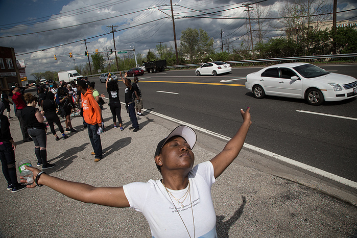 Naima Moore-Turner savors the first drops of a rain storm as the marchers near D.C.