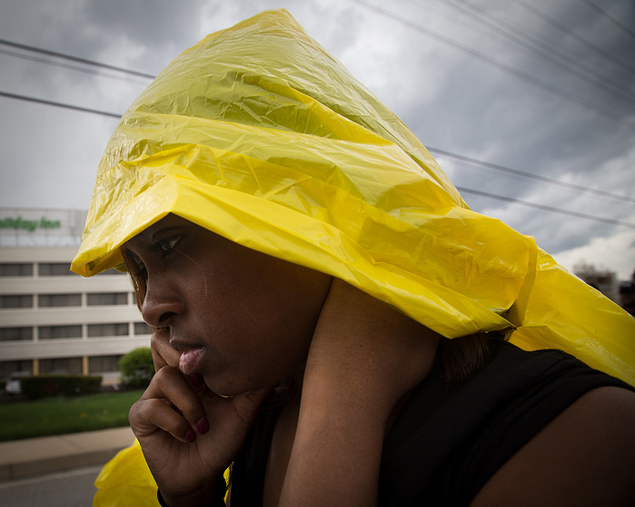 March co-Chair Tamika Mallory organizes efforts by phone while marching through a rainstorm near D.C.
