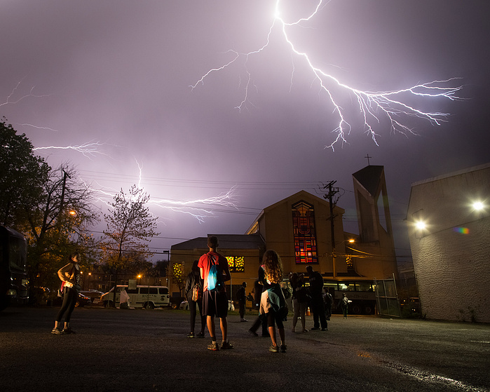 Marchers watch a lightning storm unfold over Union Temple Baptist Church after finally arriving in Washington, D.C.