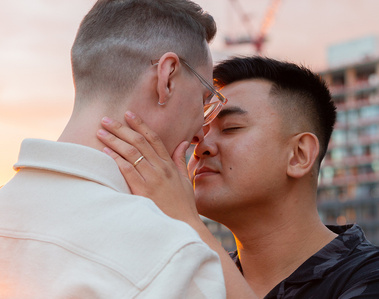 Close-up of LGBTQ+ couple embracing each other with sunset background in Toronto.