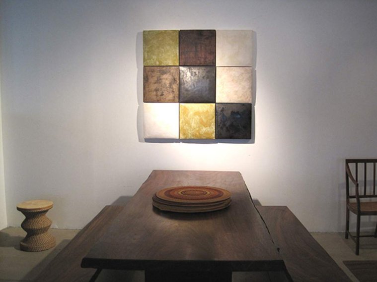 This Tucker Robbins Room Installation by artist Kathy Erteman features hand-built stoneware squares that measure 15-inches. The wall sculpture in earth tones was a collaboration between designer Tucker Robbins and Erteman