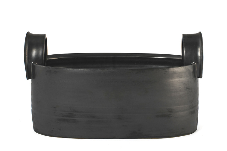 Kathy Erteman’s Pewter Long Vessel with Handles was wheel thrown from stoneware and altered. The pewter matte glaze on the vessel and handles makes this a handsome contemporary ceramic piece inspired by a farm bucket design
