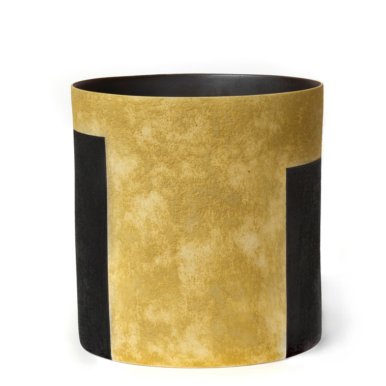 Tall Ochre Vessel, a wheel thrown and altered stoneware vessel by Kathy Erteman has an ochre dry glaze with black glazed rectangles. The tall ellipse is a minimal, reductive design.
