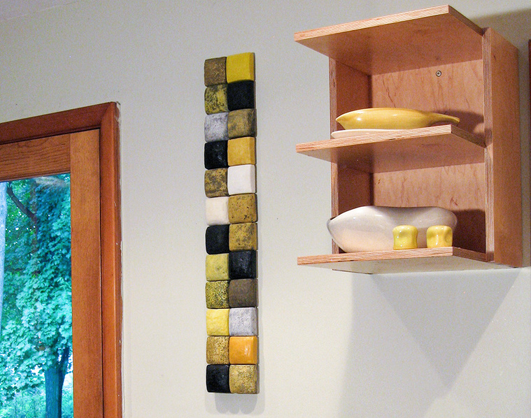 This image of the York Installation shows a contemporary ceramic design of two- inch slip-cast dimensional ceramic squares mounted on panel. Produced by artist Kathy Erteman, the sculpture was a commission for a residential design project