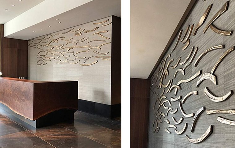 Angled view of the Catalpa Wall Installation, a commission for a large-scale ceramic wall sculpture awarded to artist Kathy Erteman for The Avery in San Francisco. Shown here behind the front desk, it is made of stoneware that was hand-sculpted