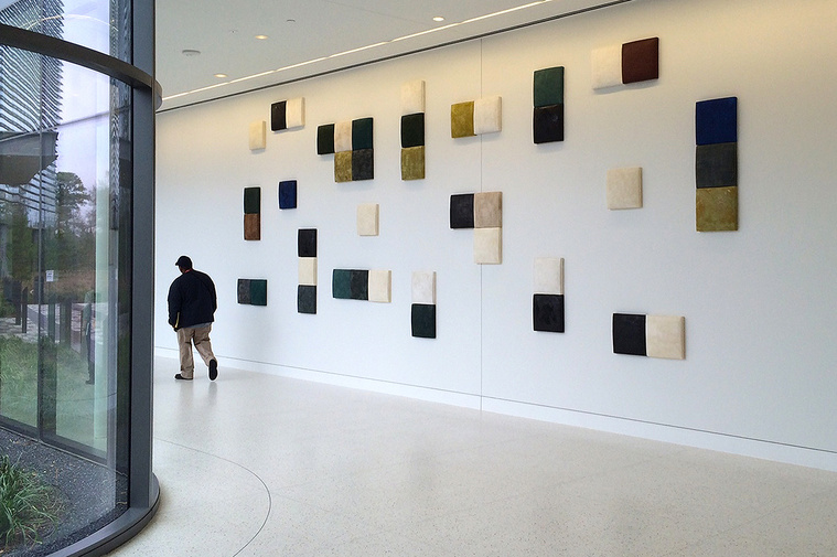 An installation of Kathy Erteman’s ceramic wall squares was chosen by Gensler Architects for the SWN Corporate Headquarters. The large-scale architectural wall art has varying colors of black, white, ochre, and grey textured glazes in a varied pattern