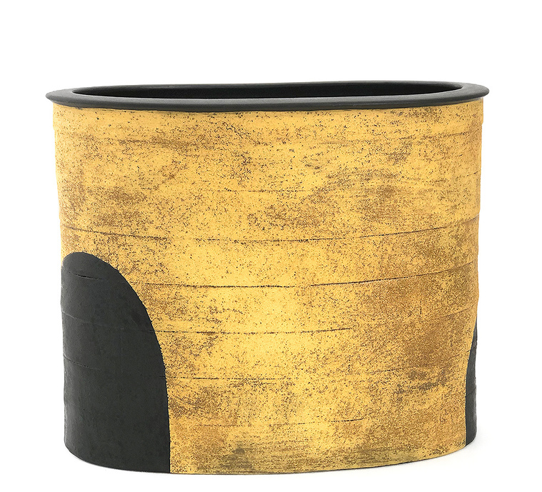 Titled Titanium + Black Orb Vessel, this hand-built narrow ellipse made of stoneware was created by Kathy Erteman. The titanium yellow texture glaze contrasts the black inset orbs. This piece was included in the 2019 International Korean Ceramic Biennale