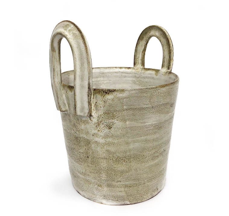 Kathy Erteman’s White Handles Vessel is made of wheel-thrown brown stoneware with a white glaze. With its tall loop handles, this piece of pottery is a textural sculpture. This ceramic piece was inspired by work buckets