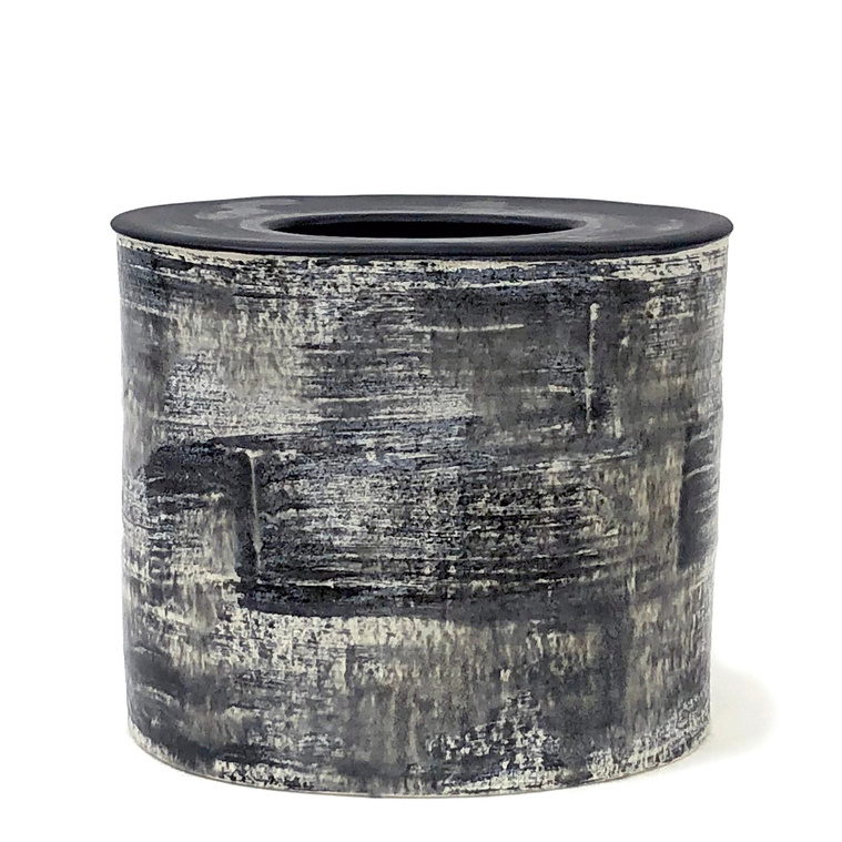 Artist Kathy Erteman created the Brush + Bleed, Drum Vessel made of hand-built Stoneware. The contemporary ceramic vessel with a white gloss glaze, and black brushwork drips and bleeds.