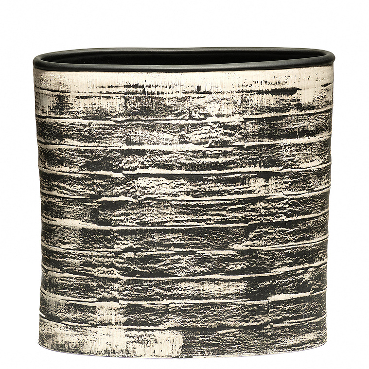 Brush Vessel, an oval stoneware vessel was hand-built in strips by Hudson Valley-based artist Kathy Erteman. The smooth wheel thrown black bead rim, contrast with the textural painted white brushwork of the contemporary al form.