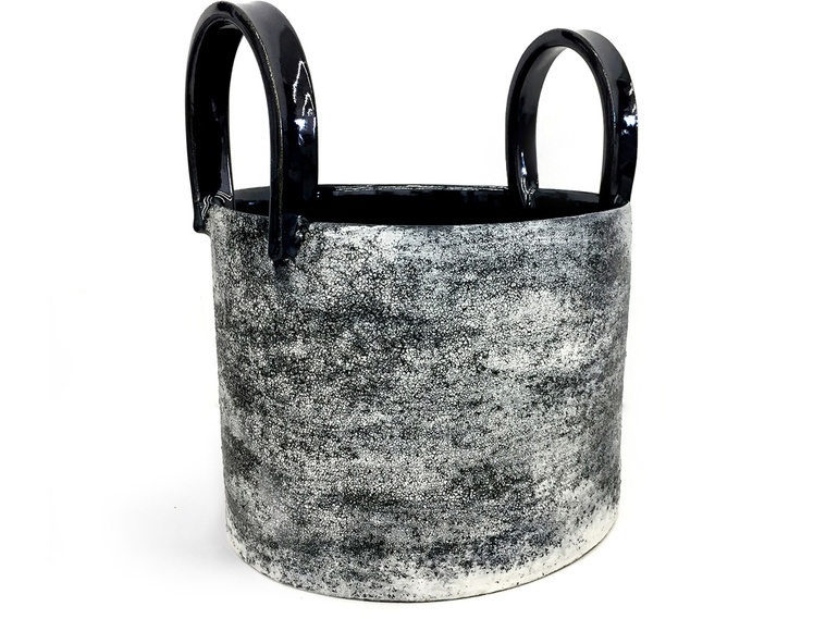 Titled Black/White Texture Handles Vessel, this wheel thrown stoneware sculpture by Kathy Erteman has a black and white texture glaze with a gloss black glaze on its tall handles and interior; the contemporary vessel was inspired by utilitarian buckets