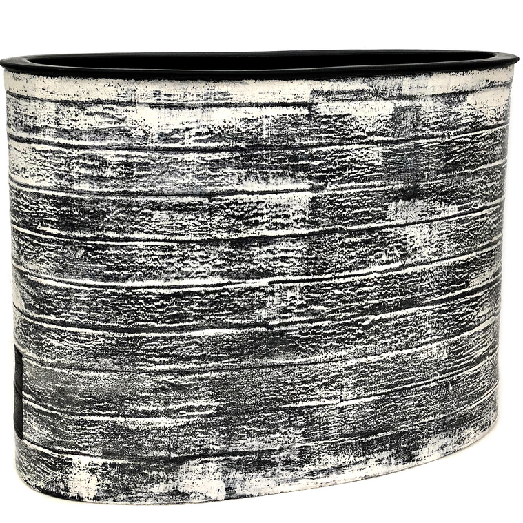 Inspired by abstract expressionism, Kathy Erteman’s Black Frost Vessel is a large oval vessel hand-built from stoneware in strips with a wheel thrown rim and inset black square. The surface has black slip and white slip brushwork