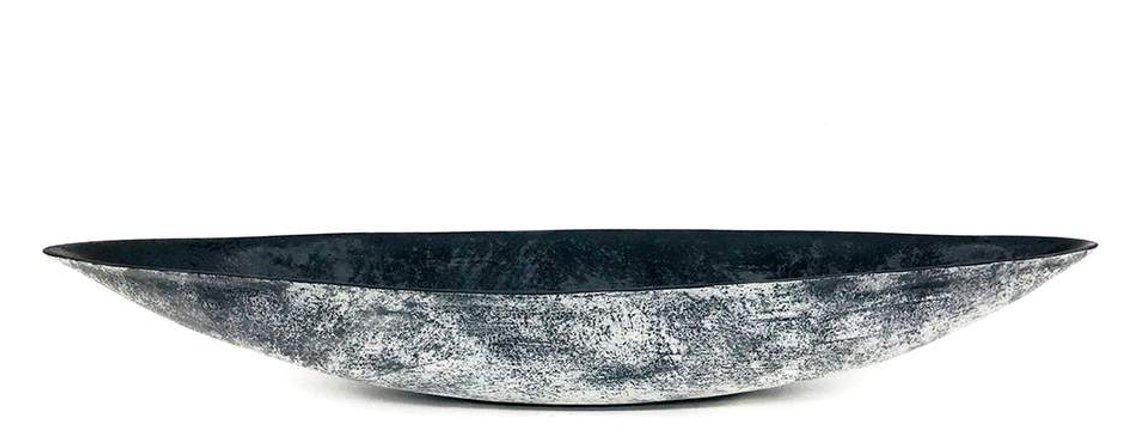 White and Black Boat is a stoneware vessel hand-built by artist Kathy Erteman, who is known for minimal forms and sculptural clay objects. Slab-built, the oblong ceramic sculpture has a black glazed interior, and a black and white textured exterior. 