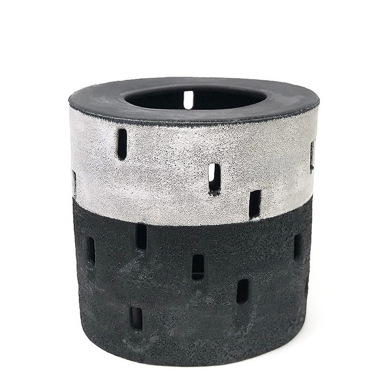 The Half Night, Tulou Vessel is an oval ceramic black and white sculpture hand-built in strips by artist Kathy Erteman. The fortress-like exterior with its pierced window cutouts was inspired by Tulou architecture