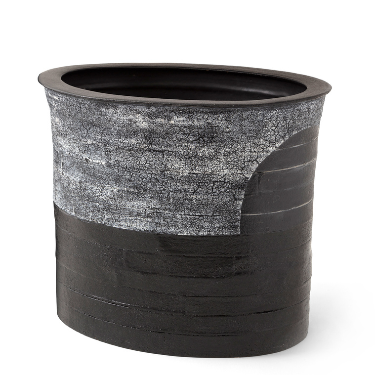 Crescent Vessel, a hand-built stoneware oval vessel was built with strips by Kathy Erteman. The Hudson Valley-based artist then created the wheel-thrown rim, which contrasts the white texture glaze on the crescent design