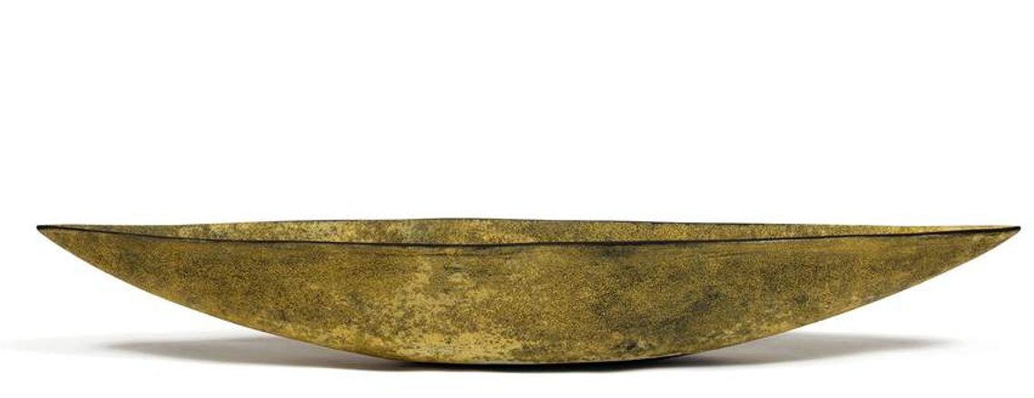 In her Hudson Valley studio, artist Kathy Erteman creates hand-built stoneware sculptural clay vessels like the Gold Yellow Boat with a textural surface in a dark yellow over black texture glaze, a large-scale ceramic vessel for interior centerpieces