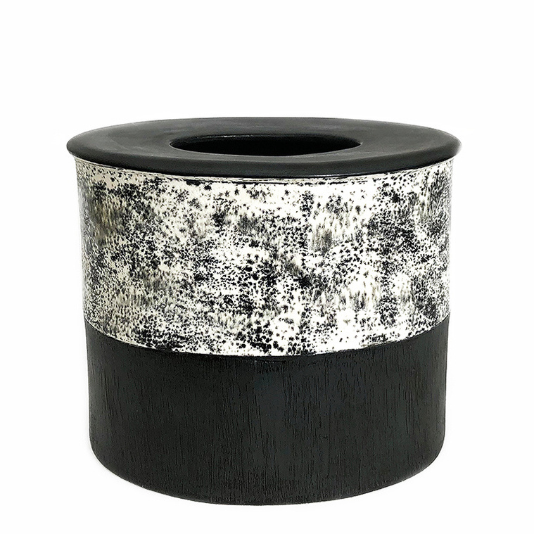 Kathy Erteman created the Black + White Speckle Drum Vessel, a hand-built stoneware oval vessel covered in a white glaze with drips and speckles above black. The closed top is an architectural modernist reference