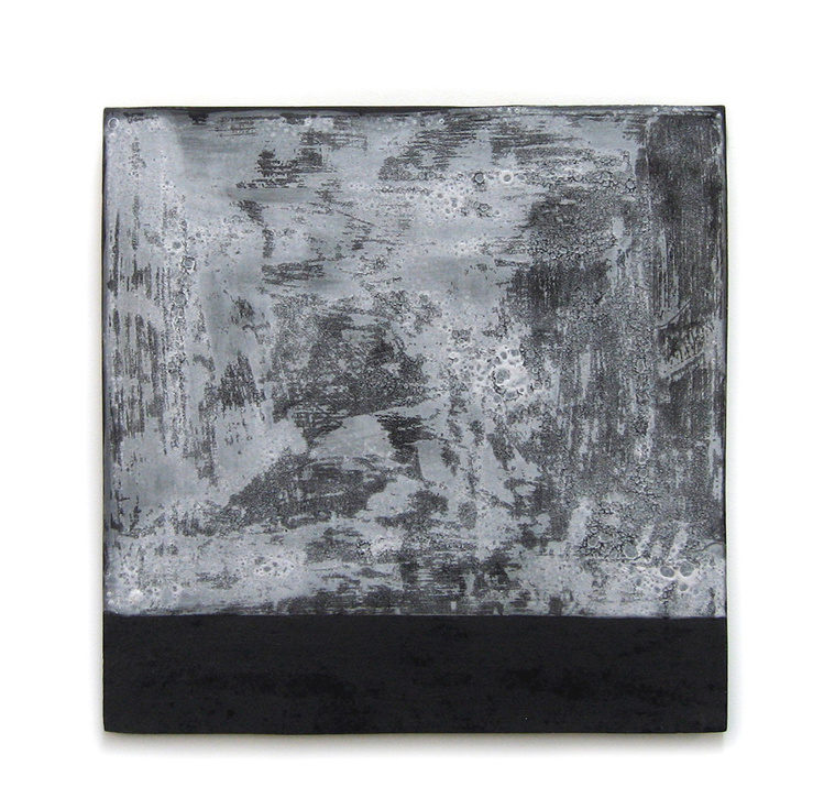 The Asphalt & Snow porcelain tablet is an example of how artist Kathy Erteman uses clay as canvas. This porcelain wall piece is glazed using a monoprint technique. The black and white wall sculpture has a hanging cleat.