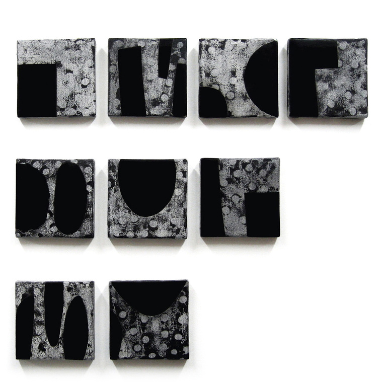 After Ryoangi is an installation of multiple four-inch ceramic wall squares in black and white by artist Kathy Erteman. Created with monoprint and images, the staggered placement of the wall sculpture was inspired by a famous Japanese temple of that name