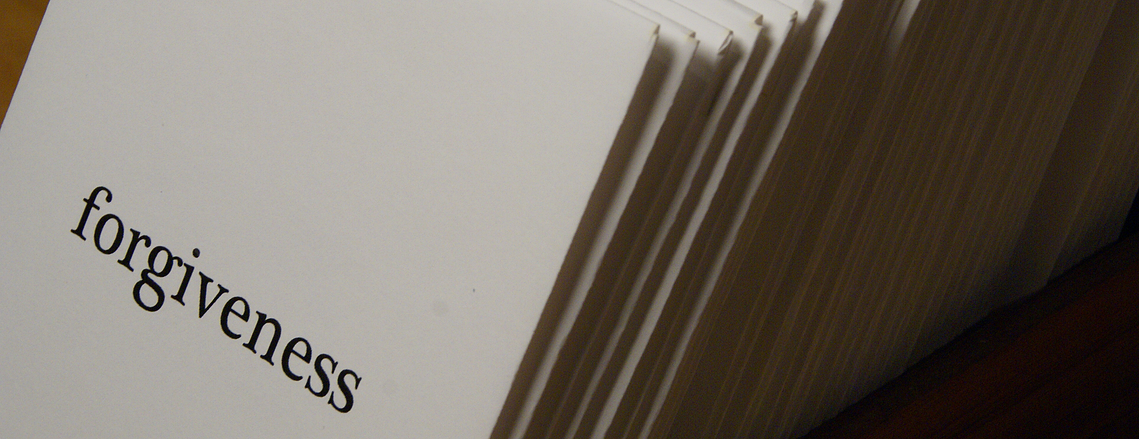 photographs from douglas rosenberg's relational performance art work forgiveness, showing white envelopes from the performance labeled forgiveness, containing hyacinth seeds