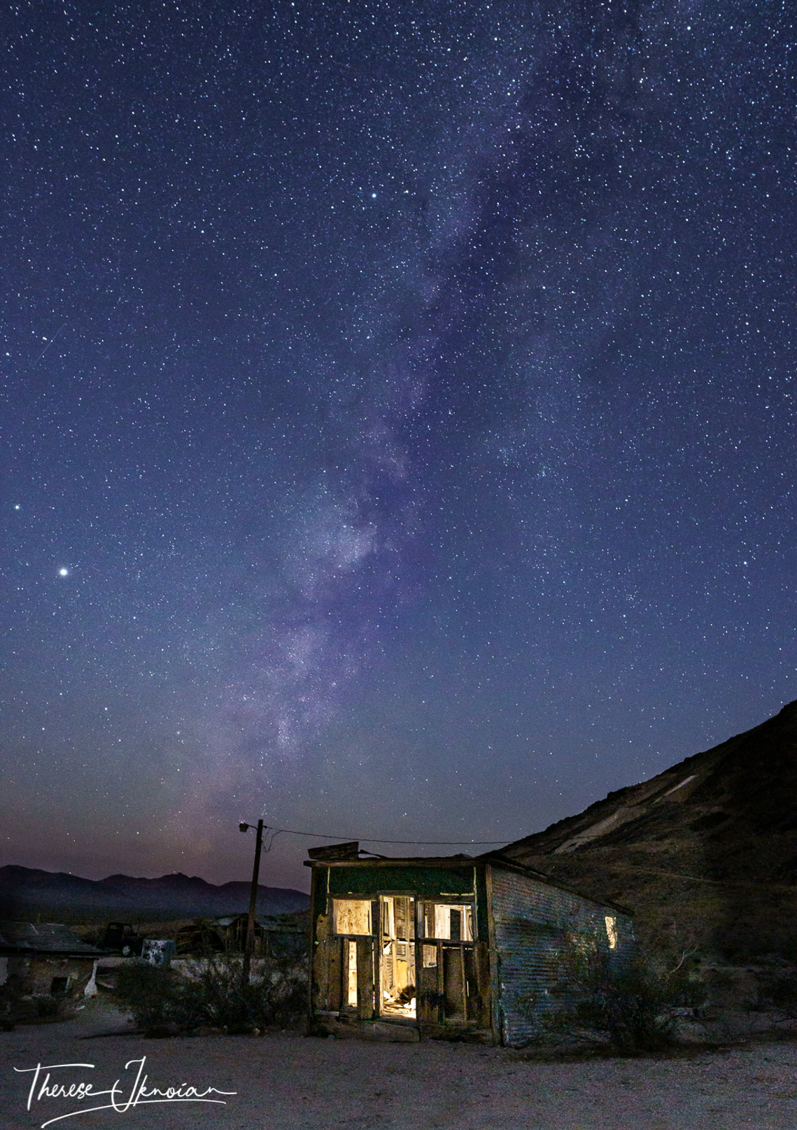 Illuminated shack in Rhyolite Ghost Town in Nevada, part of Death Valley National Park in California. 