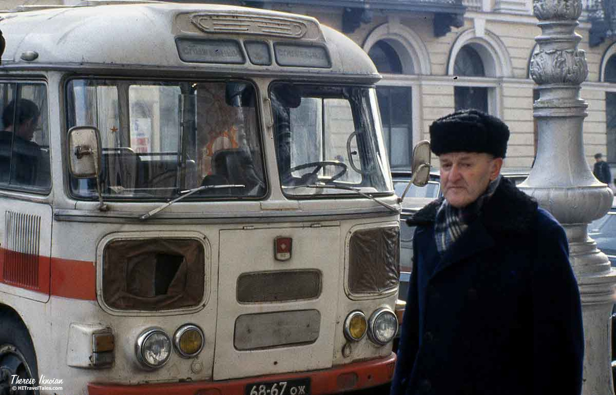 Historic 1984 photo of a man walking in front of a bus in then-Leningrad (now St. Petersburg).
