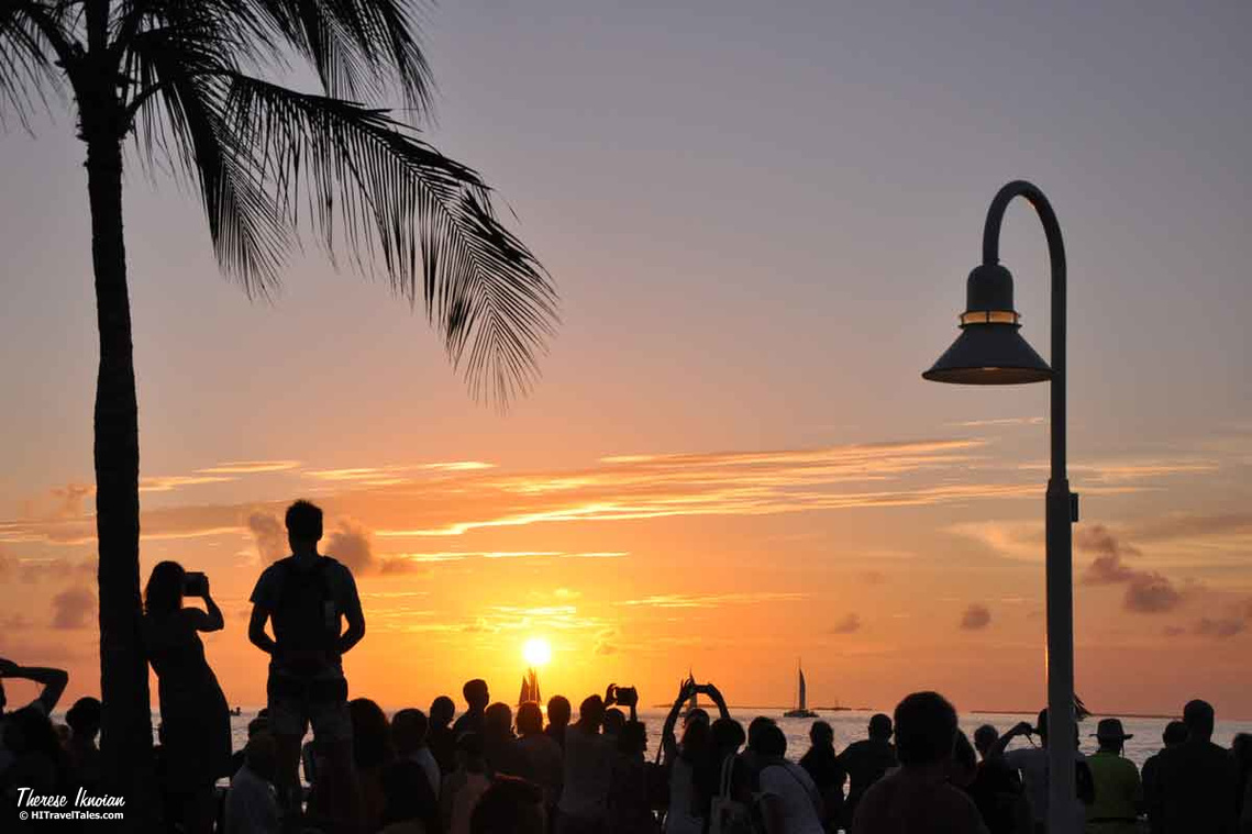 Photo of a crowd and beautiful sunset at the  Sunset Celebration in Key West, Florida. 