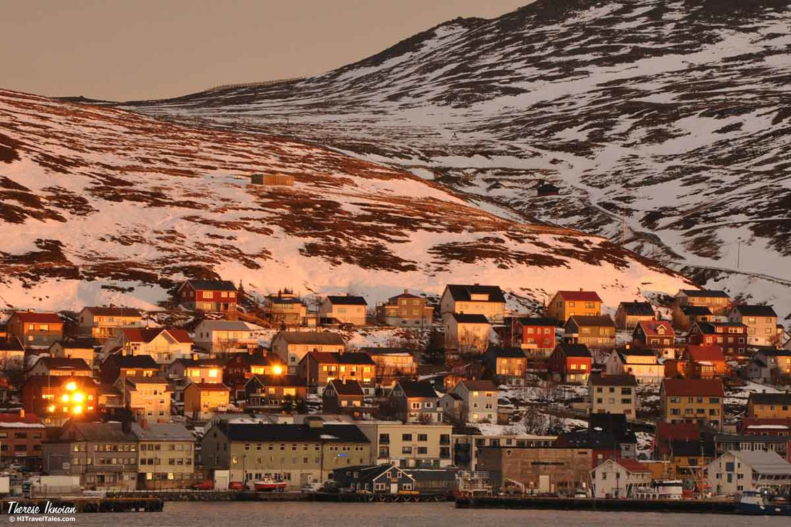 Light illuminates buildings and windows of Honningsvag as the sun was low in the sky in November.