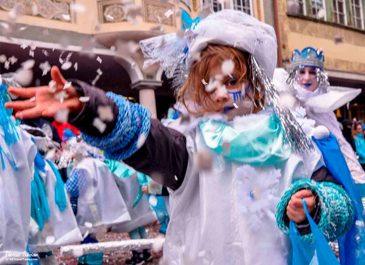 A child tosses confetti at a Carnival parade in Altstatten, Switzerland.