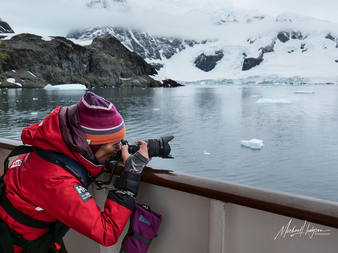 Therese Iknoian taking a photo from the Polar Latitudes ship in Paradise Bay, Antarctica. 