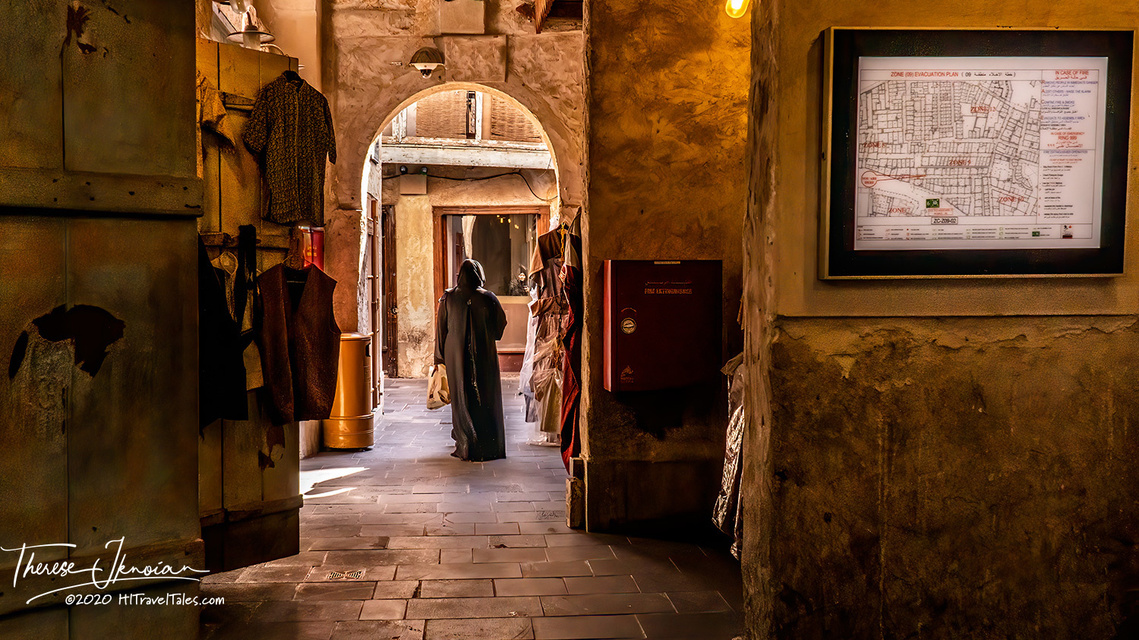 A woman walking through the old souk market area of Doha, Qatar. 