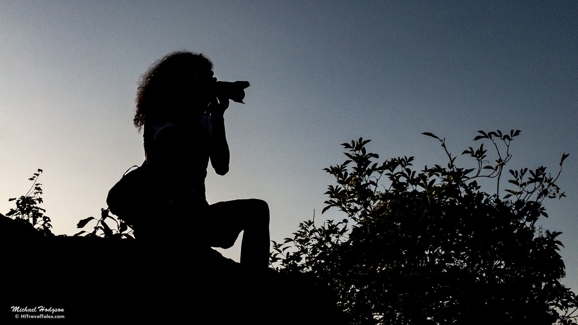 A silhouette of a photographer on the walls of a castle overlooking Dürnstein in Austria.
