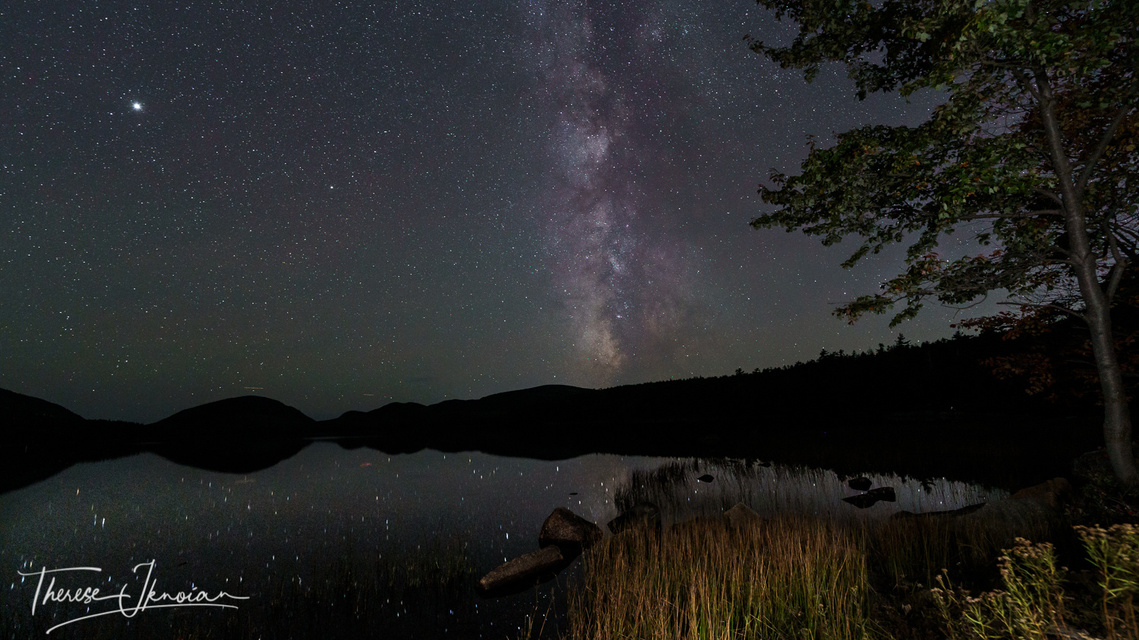 The Milky Way dances above Eagle Lake in Acadia National Park in Maine.