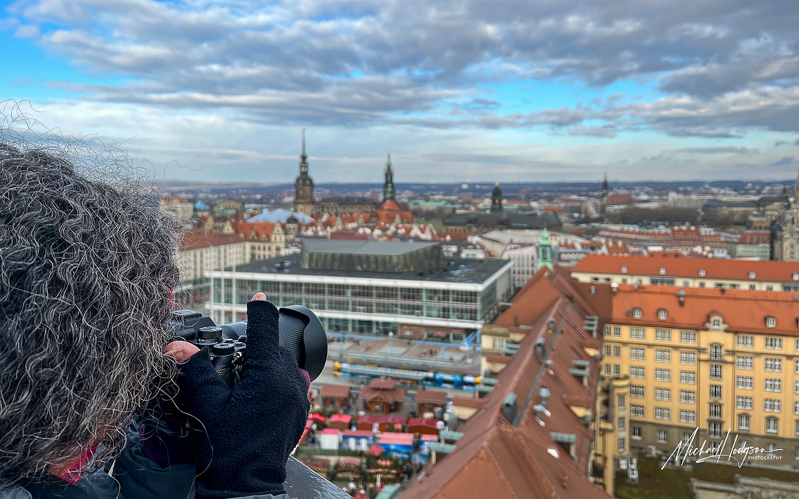 Therese Iknoian taking a photo from a church tower looking over the skyline of Dresden, Germany. 