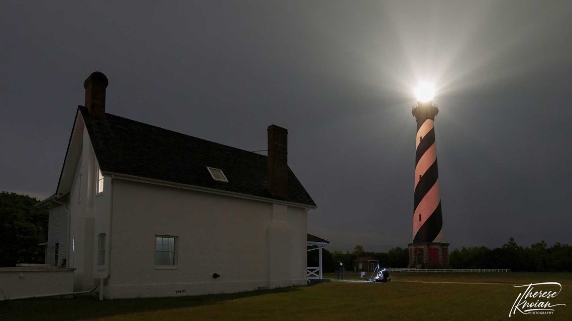 Cape Hatteras in the Outer Banks showing red glow on lighthouse from blinking red lights from far away transmission tower