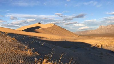 Hikers cast distant shadows in the Mojave desert.