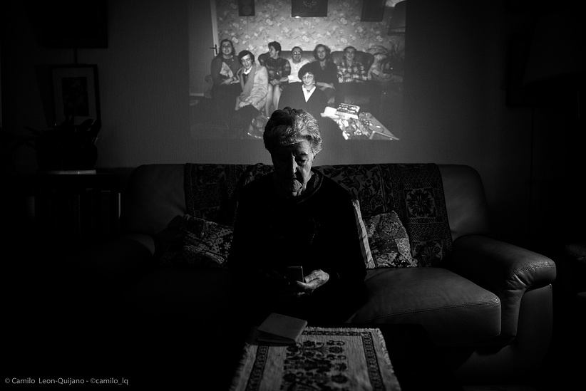 ​Maryse. In the background a screened photograph of her family made in the 80&#x27;s.