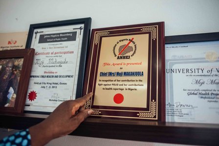 Moji Makanjuola shows off some of her career awards and certifications at her office in Garki, Abuja, Nigeria on Wednesday 16 December 2020. KC Nwakalor for Global Citizen.