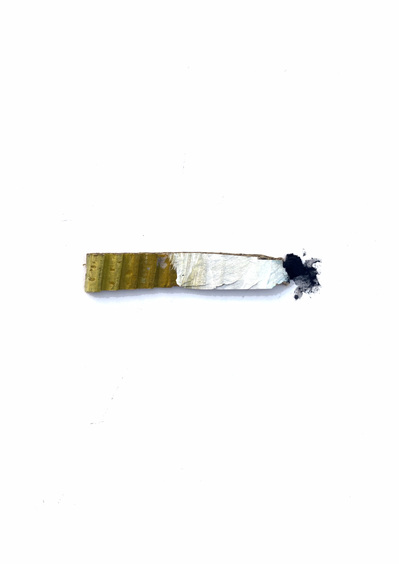 A small cardboard cutout of a cigarette. Made by artist Mary Naylor. Created during her Mothership NewYork City Residency.
