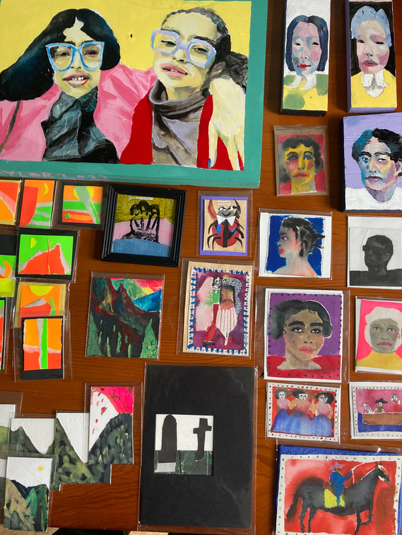 A table display of portraits big and small , drawn and also painted. The small drawn ones are human hand sized and are packaged ready to sell. They belong to Artist Mary Naylor. She is preparing for the Art Market taking place at The OPO in Scarborough