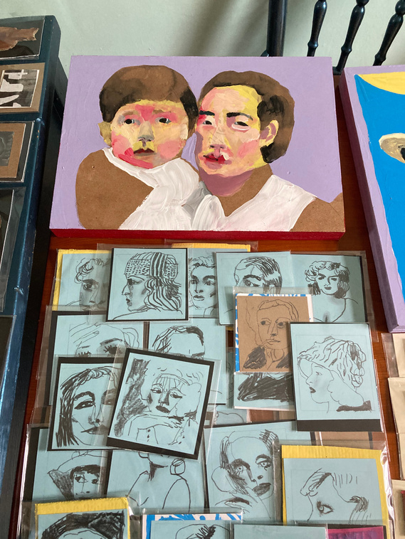 A table display of portraits big and small , drawn and also painted. The small drawn ones are human hand sized and are packaged ready to sell. They belong to Artist Mary Naylor. She is preparing for the Art Market taking place at The OPO in Scarborough