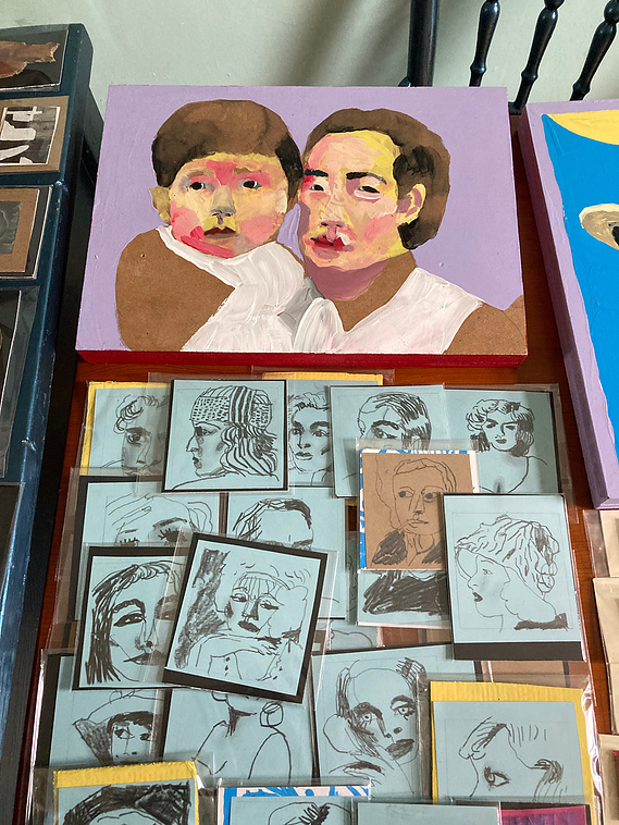 A table display of portraits big and small , drawn and also painted. The small drawn ones are human hand sized and are packaged ready to sell. They belong to Artist Mary Naylor. She is preparing for the Art Market taking place at The OPO in Scarborough