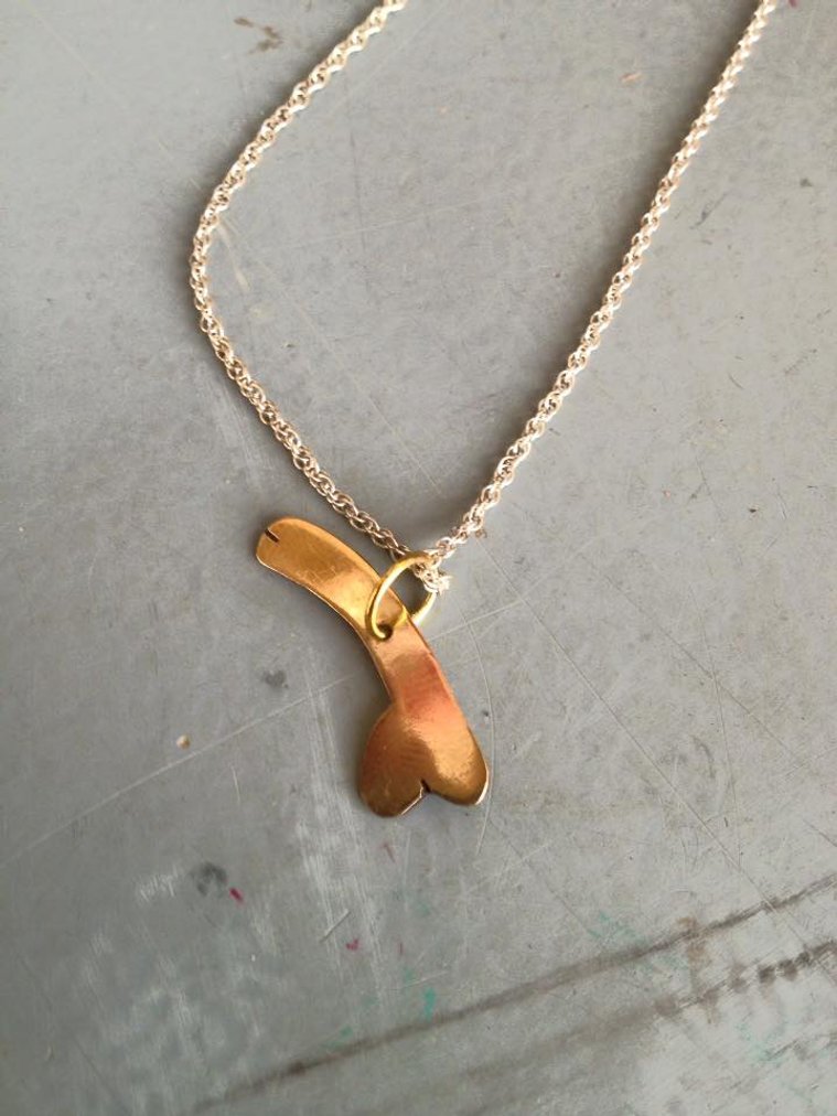 Small Gold necklace designed by Artist Mary Naylor.