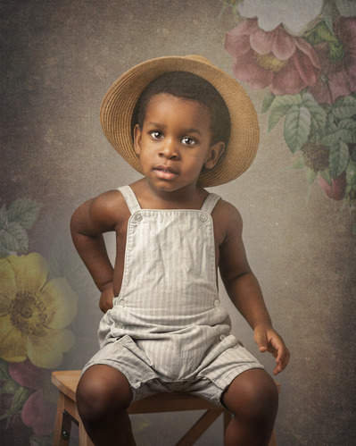 Child portrait of a little boy with a beautiful floral background
